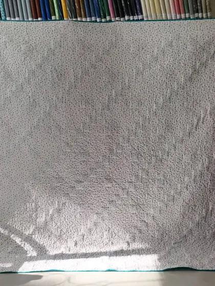 The simple dotted backing fabric for the diagonal star quilt.
