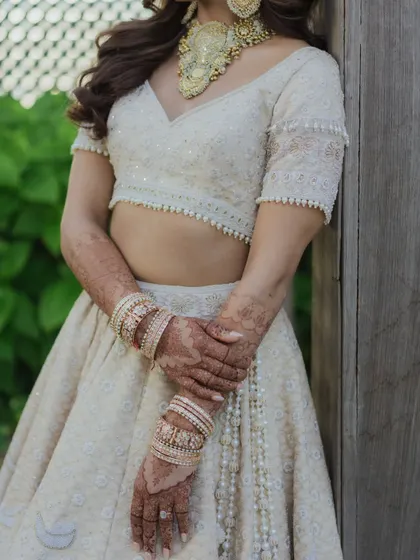 A focus on the intricate details of Sheena's outfit and her beautifully manicured hands with henna. Every detail matters on the wedding day.