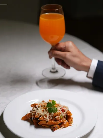 A perfectly plated dish of penne pasta, ready to be served at a corporate event. We believe that even for large gatherings, every plate should be presented with the care and elegance of a fine dining restaurant.