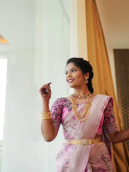 A candid shot of a bride by the window, her face lit up with a joyful smile.