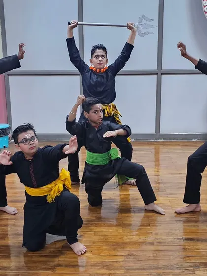 My young students in a powerful pose during a Mayurbhanj Chhau class, with one holding a trishul prop. They are learning the fundamentals of this martial dance.