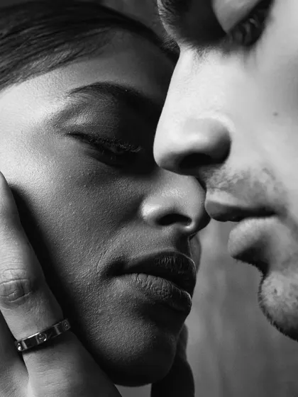 An intimate, close-up shot in black and white. Removing color allows the focus to shift entirely to emotion, texture, and the play of light and shadow on the skin.