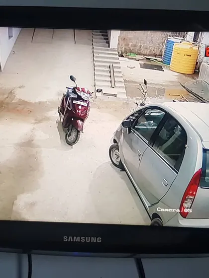 This camera is monitoring a parking area, keeping an eye on vehicles.
