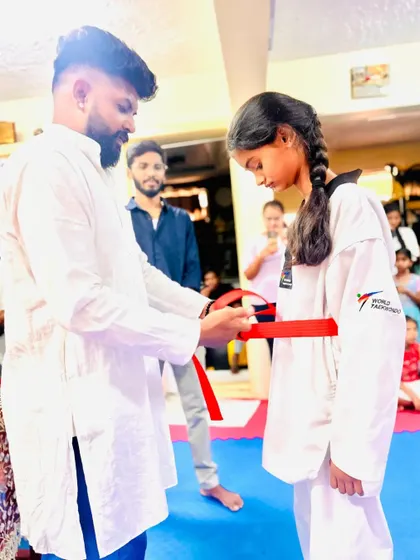 This young lady has earned her red belt through consistent effort.