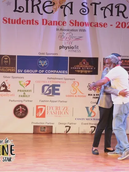 A warm hug of appreciation on stage at the "It's Time to Shine" showcase.