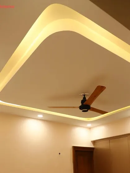 A close-up of a modern, curved tray ceiling design, showing how the soft cove lighting creates a beautiful, ambient glow.