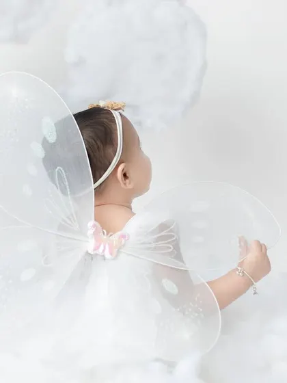 A glimpse of her delicate fairy wings. This shot from the back is so artistic and sweet, showing a different perspective.