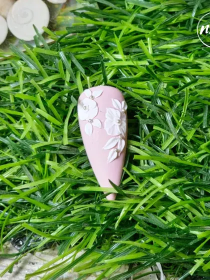 A collection of various nail art samples, from celestial and gold-leaf designs to embossed sweater patterns and fruit art, all showcasing the diverse skills our students learn at the academy.