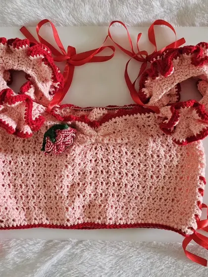A flat-lay of the Avery Top, showing the beautiful construction, frilly sleeves, and ribbon ties.