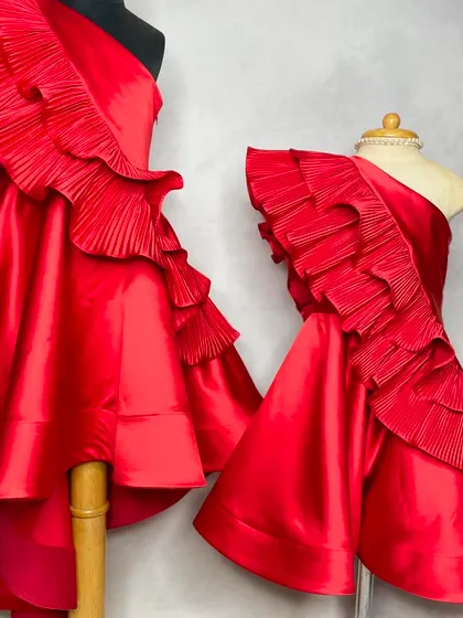 The Red Desire Dress, designed for making a statement. This one-shoulder dress with dramatic ruffles is perfect for a birthday girl who loves to be in the spotlight.