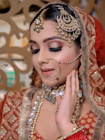 A soft and romantic close-up. The bride's gentle touch to her face and her closed eyes convey a sense of peace and happiness.