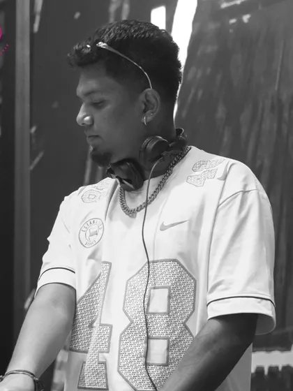 A black and white portrait of me at the DJ booth. This artistic shot captures the serious focus I put into my craft.