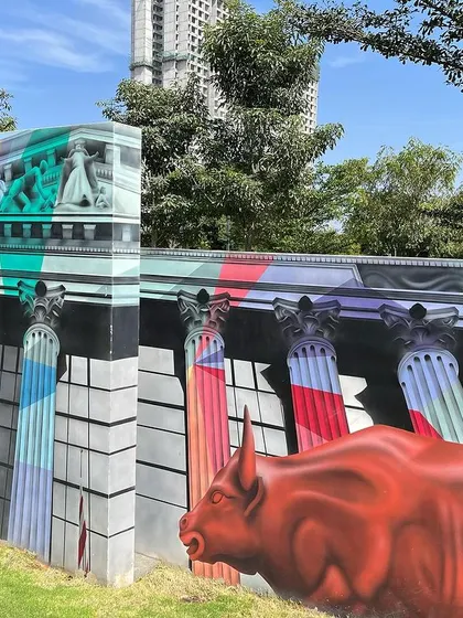 Different angles of the Wall Street and Broadway inspired sections of the Sobha mural. The piece combines hyper-realistic architecture with bold, colorful overlays, capturing the dynamic spirit of Manhattan.