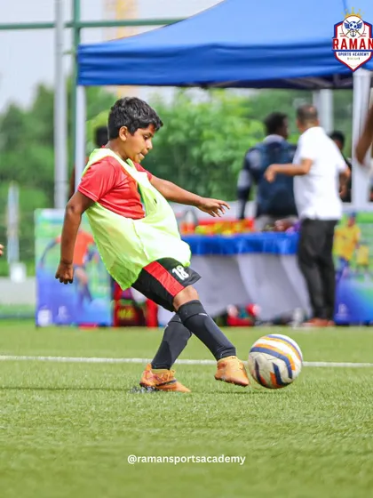 A young player strikes the ball during a match in the OneFootball Championship.