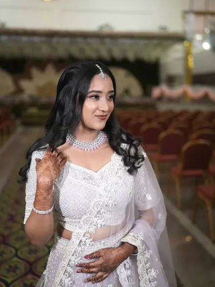 Another angle of this stunning reception look. The soft waves in her hair and the delicate embroidery on her lehenga are perfectly complemented by the makeup.
