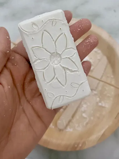 The finished product: a beautifully carved flower on a bar of soap. This activity shows how simple, everyday materials can be transformed into art.