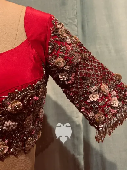 A close-up of the sleeve of Meghana's blouse, showing the 3D flowers and crystal latkans.