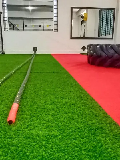 This is our functional training zone, complete with turf flooring, battle ropes, and a tire for high-intensity workouts.