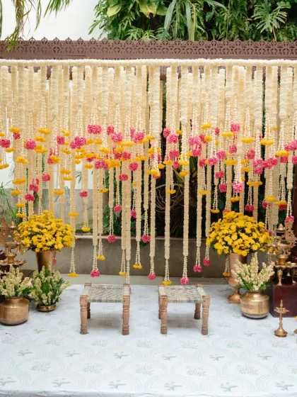 A fusion of cultures. For this North Indian couple who fell in love in Pondicherry, we designed a Haldi and Mehendi evening that blended traditional South Indian elements like banana leaves and brass lamps with vibrant floral decor.