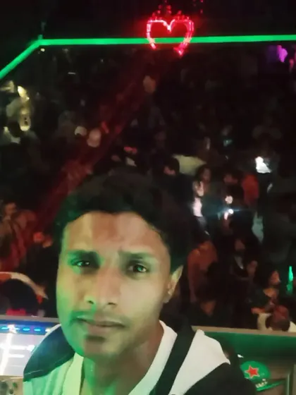 A selfie from the DJ booth with a massive crowd behind me and a neon heart glowing above. The love from the crowd is real.