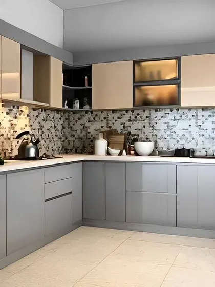 A sophisticated L-shaped kitchen with glossy grey base cabinets, beige uppers, and a mosaic tile backsplash.