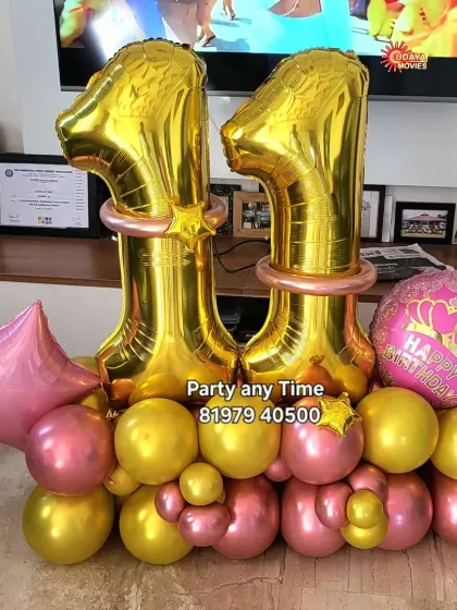 A bright and cheerful 11th birthday balloon bouquet in pink and gold.