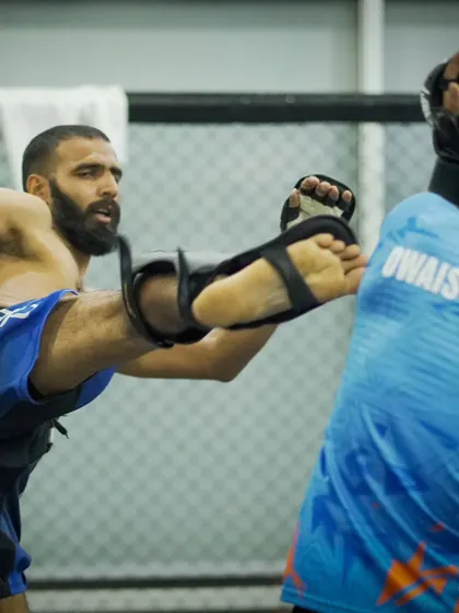 A fighter throws a high kick during a sparring session. We encourage creativity and the development of a diverse arsenal of attacks.