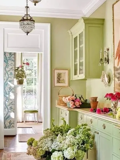 A beautiful example of a nature-inspired palette. The soft, sage green on the walls and cabinetry creates a seamless and calming flow through this open-plan space.