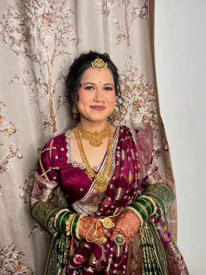 A close-up of her makeup, showing the soft, natural finish that complements the rich colours of her outfit.