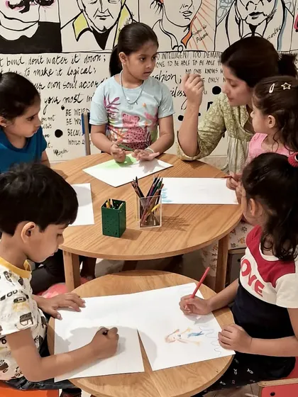 Concentration and creativity at the drawing table. During our Read-a-thon, kids listened to stories and then brought the characters and scenes to life with their own colorful illustrations.