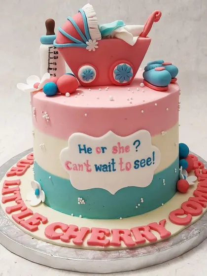We build anticipation with this classic "He or She? Can't Wait to See!" gender reveal cake. Pink and blue stripes, a baby carriage, and tiny booties create a sweet and traditional design for a baby shower celebration.
