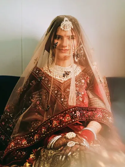 A dreamy bridal portrait with a soft, hazy filter, showing the bride looking elegant under her veil.