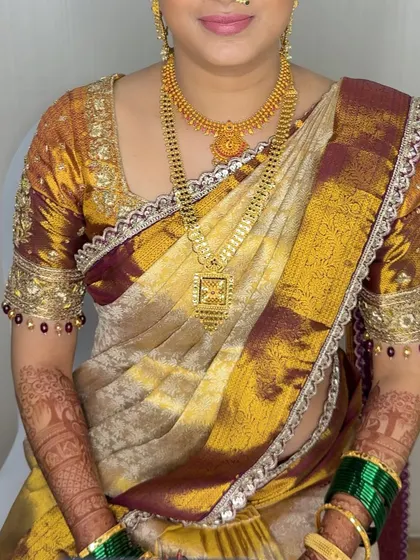 A candid moment with the bride, showcasing her complete look with intricate jewelry and perfectly draped saree.