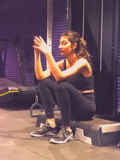 A candid moment of a client resting on a step box. It's in these moments of recovery that your body adapts and gets stronger.