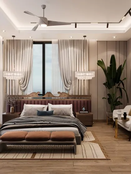 A full view of the bedroom, highlighting the gallery wall and layered window treatments. The design uses a warm, neutral palette with pops of color to create a welcoming and stylish space.