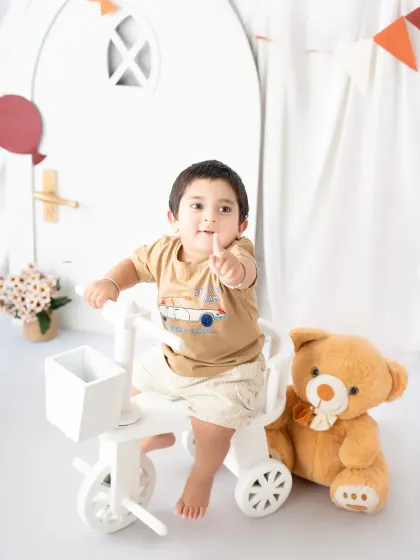 Capturing a toddler's playful side as he points with excitement. These interactive sessions are designed to bring out your child's natural personality.