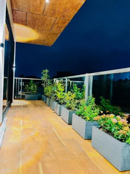 This third-floor deck was designed for comfort and conversation. We used a series of sleek, lightweight fiberglass planters filled with low-maintenance plants to create a lush but uncluttered environment with beautiful night lighting.