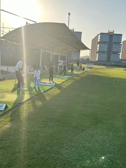 The driving range bathed in the golden hour light during a birthday celebration. It’s a picturesque setting for making memories.