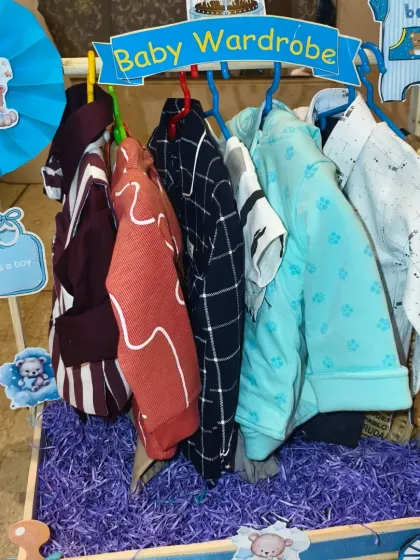 A full view of the baby boy's wardrobe section, with clothes neatly arranged on hangers.