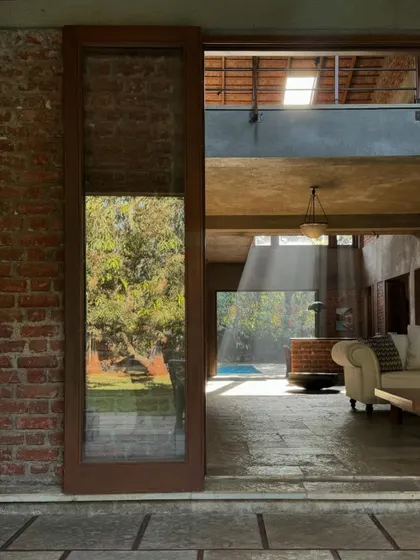 A quiet moment at The Mango House, where a beam of light cuts through the space. The design plays with light and shadow, using skylights and large openings to create a constantly changing atmosphere throughout the day.