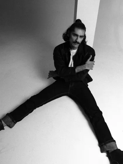 A dramatic, wide-legged pose in black and white, emphasizing geometric shapes and lines.