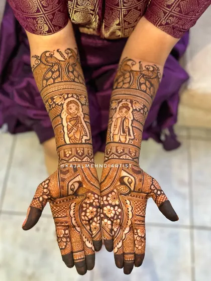 A complete view of a stunning Maharashtrian bridal design. The symmetrical portraits on each arm are balanced with graceful peacocks, creating a truly regal look.