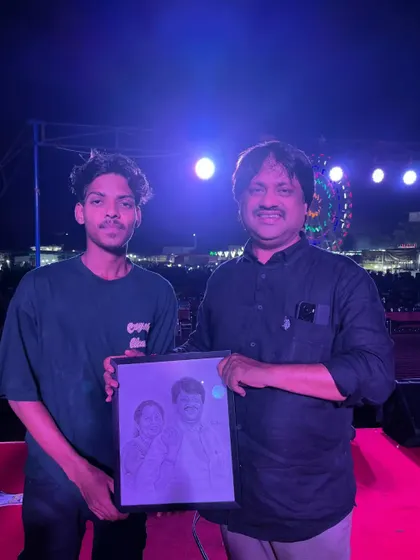 Presenting a framed portrait to a respected dignitary on stage during a public event. It is an honor to have my art be part of such important occasions.