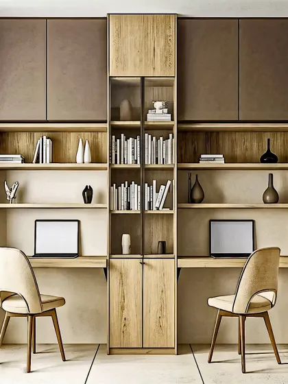 For modern homes, we design productive and stylish work-from-home spaces. This dual workstation provides a symmetrical setup with two separate desks, ample open shelving for books, and concealed overhead cabinets, all unified by a central storage column.