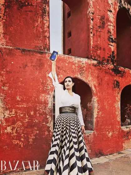 In a feature for Harper's Bazaar, holding up a copy of the Constitution. I see it not just as a shield to protect our rights, but as a sword to actively fight for justice, equality, and the principles of our democracy.