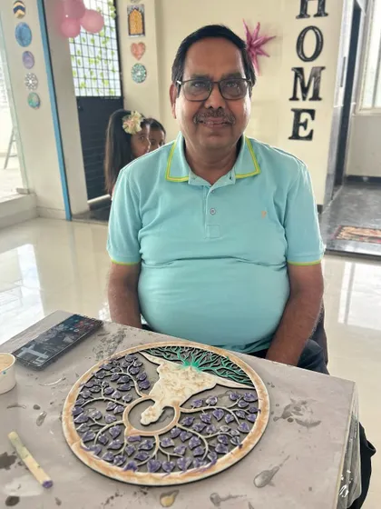 A happy participant with his finished 'Tree of Life' texture art piece.