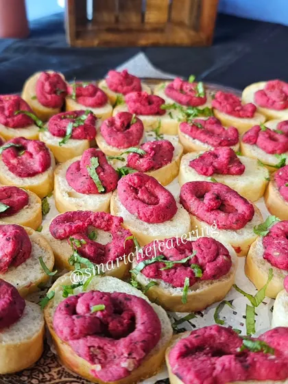 A vibrant and unique appetizer: crostini topped with a swirl of beetroot hummus. This was a highlight at a recent corporate office inauguration.