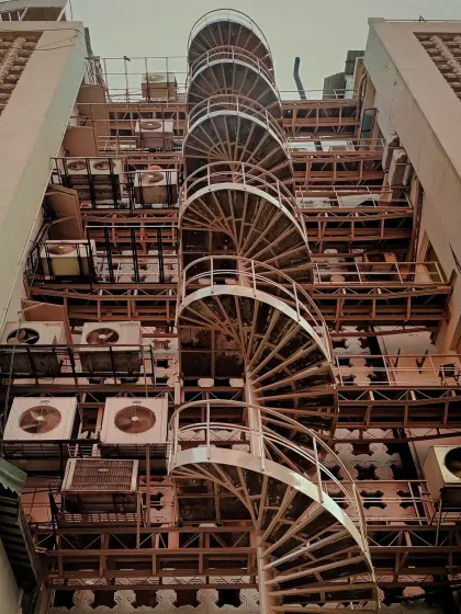 A spiral fire escape on the side of a building creates a compelling geometric pattern. I'm always looking for these unique architectural details in the urban landscape.