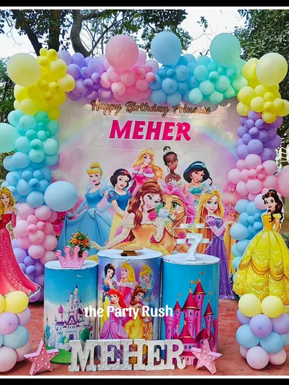 Meher's 7th birthday was a royal affair with this Disney Princess theme. The backdrop features all her favorite princesses, surrounded by a pastel rainbow balloon arch and princess cutouts, perfect for a little royal.