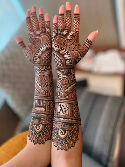 This design features bold peacock motifs at the base and personalized initials 'A' and 'V' woven into the arm bands. It's a perfect way to celebrate your union.